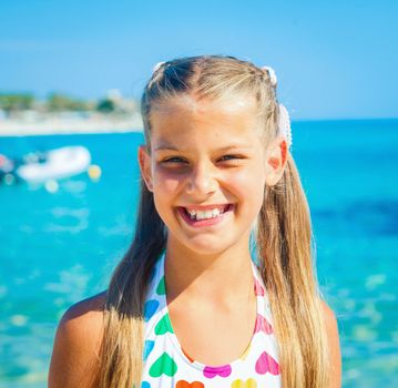 Portrait of cute happy girl on the beach