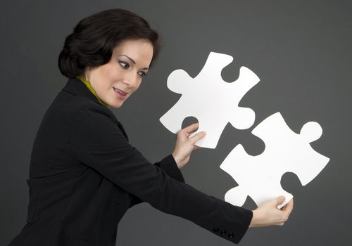 Female holding two large pieces of the puzzle