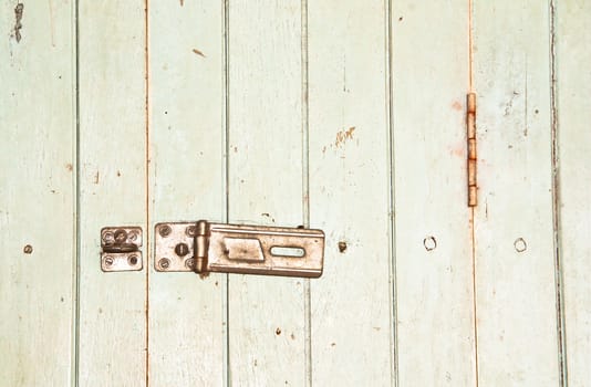 Old house door and old latch with padlock on doors.