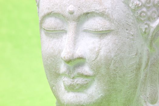 Head of smiling peaceful yoga white statue, close up