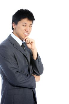 Thoughtful Asian businessman standing sideways looking at the camera with his hand to his chin isolated on white