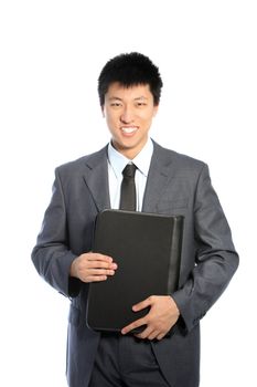 Smiling asian businessman holding a black tablet case isolated on white