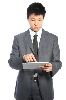 Young Asian serious businessman working on a PC tablet