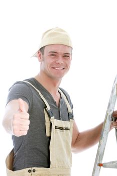 Cheerful handsome young handyman with a beaming smile giving a thumbs up of approval and success, upper body studio portrait isolated on white