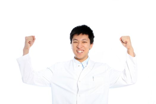 Happy excited young Asian man celebrating a success raising his fists in the air in jubilation isolated on white