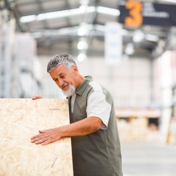 Man buying construction wood in a  DIY store