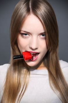 Portrait of young pretty woman with with red nail polish