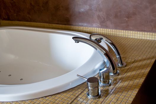 Detail of a Hotel Bathtub with chromed Faucet