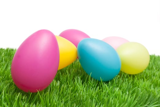 Color Easter Eggs in Grass On White Background