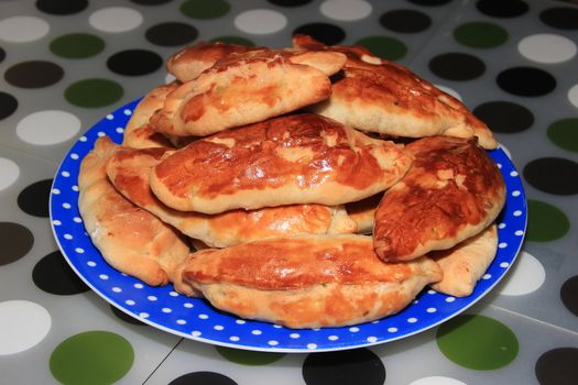 Roasted homemade pies stuffed with cabbage on a plate