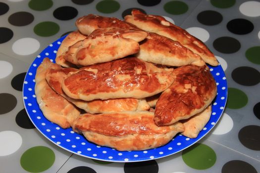 Roasted homemade pies stuffed with cabbage on a plate