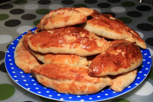 Roasted homemade pies stuffed with cabbage on a plate
