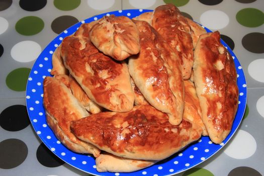 Roasted homemade pies stuffed with cabbage on a plate