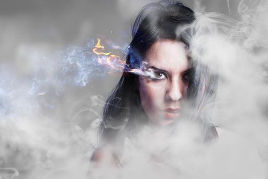 Beautiful anger, girl with burning eye, smoke