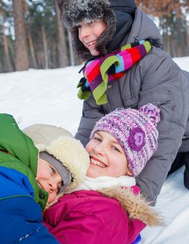 Children plaing in snow forest. Vertical view.