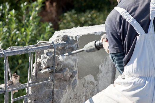 worker with machine drill in his hands