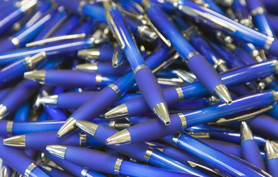 a lot of blue ballpoint pens