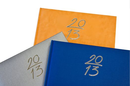 three new years notebooks in silver orange and blue color