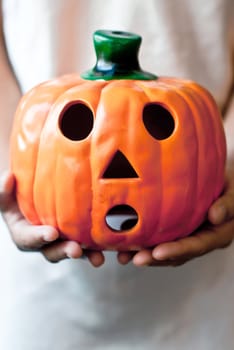 a child holds the pumpkin