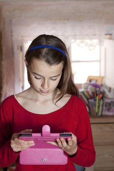 Girl looking at her electronic reader tablet