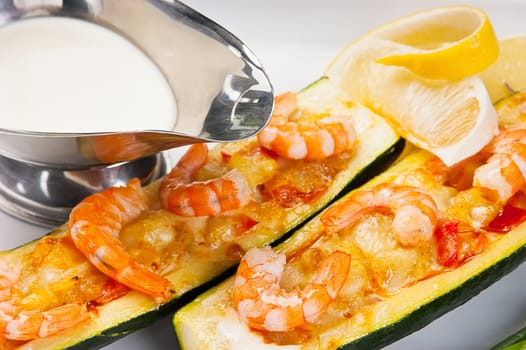 Zucchini with shrimp and sauce on white background