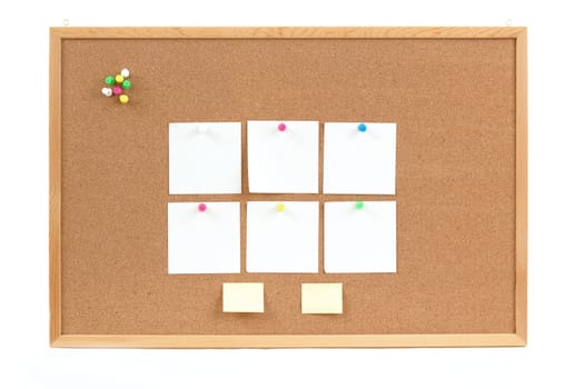 four empty note papers on cork board
