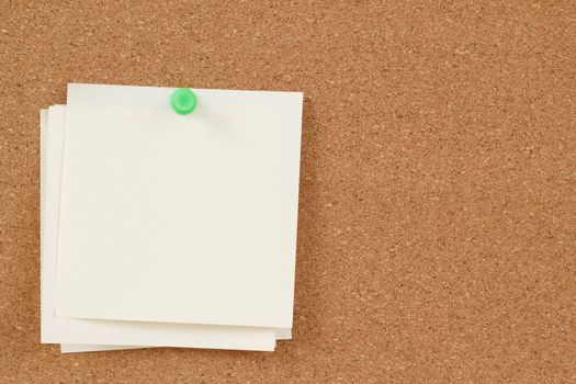 four empty note papers on cork board