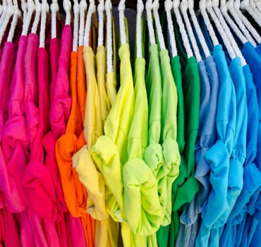 Colorful t-shirt on hangers