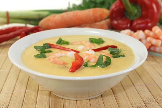 Curry soup with colorful vegetables and prawns