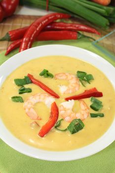 Curry soup with colorful vegetables and prawns