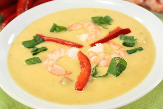 Curry soup with colorful vegetables and prawns