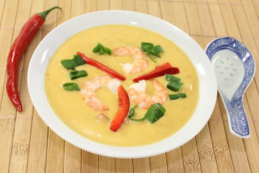 Curry soup with colorful vegetables and prawns