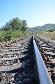 Railway track  cutting through rural countryside in summer