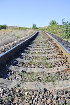 Railway track  cutting through rural countryside in summer