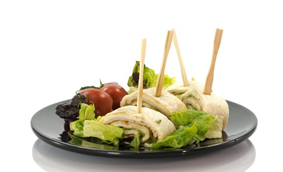 dish with salmon wraps salad and tomatoes