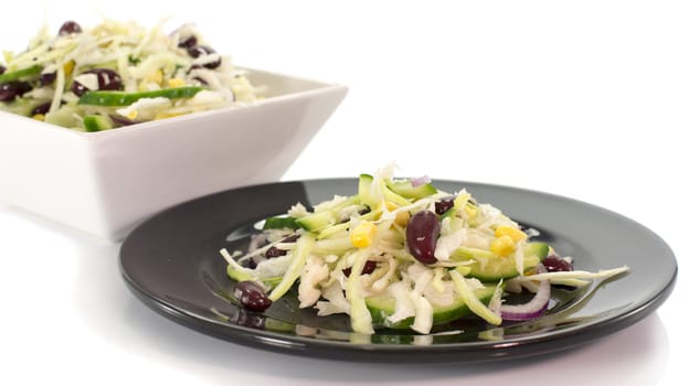 black plate with coal salad