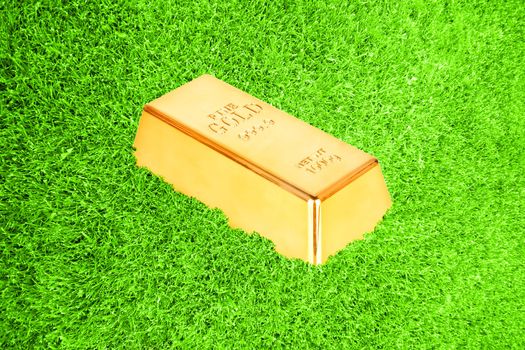Gold bar in green grass