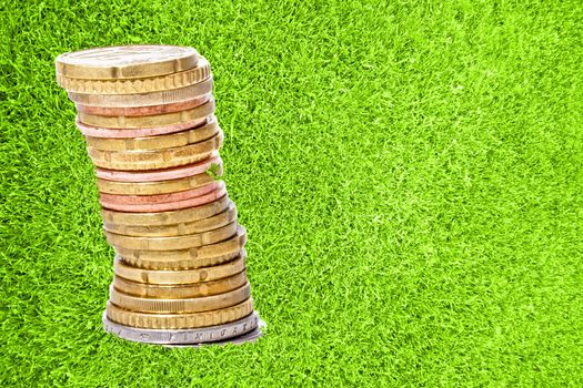 Pile of euro coins in green grass