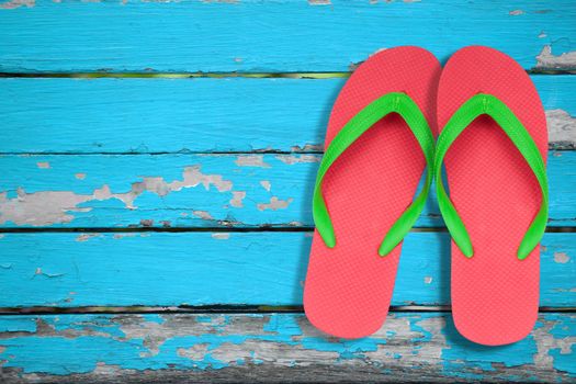 red and green flip flop sandals on blue wood