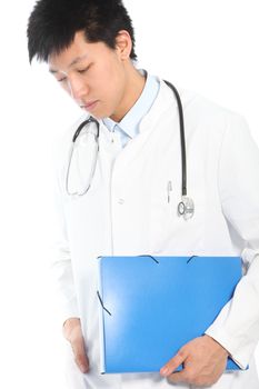 Worried Asian young male doctor looking down and holding a blue file