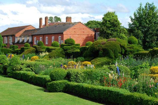 English garden and two old houses in summer