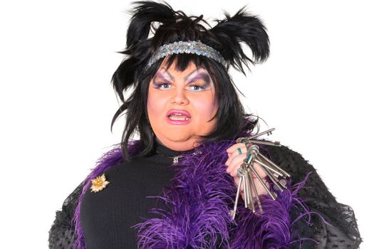 Cheerful man, Drag Queen, in a Female Suit, over white background