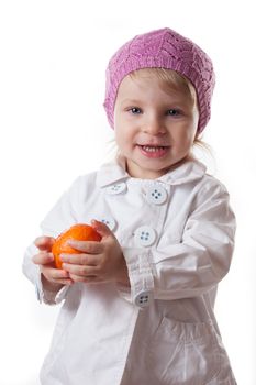 Smiling two year baby girl with tangerine isolated on white