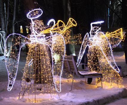 Christmas Illumination with figures of angels made of garlands, Moscow, Russia