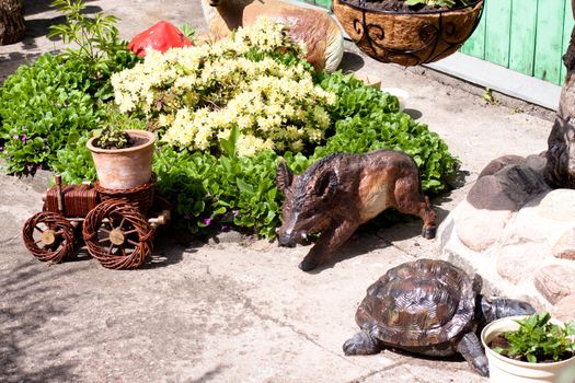 Wooden statuettes in form of turtle; boar and locomotive and flowers

