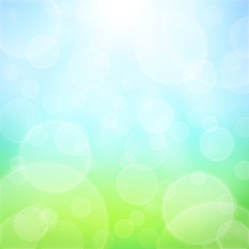 Spring abstract background with bokeh and sun rays. Grass and blue sky 