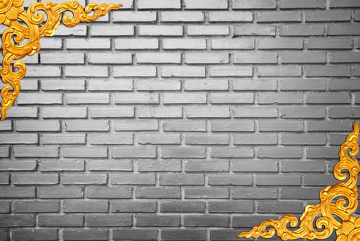 golden frame and black white brick wall