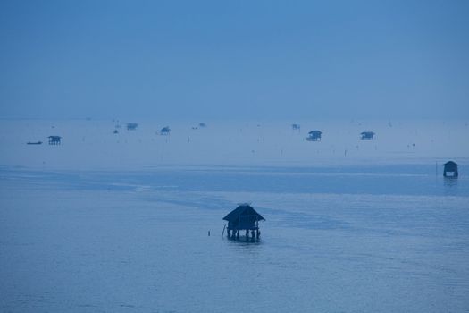 Coastal fish farming with blue tone on sunrise