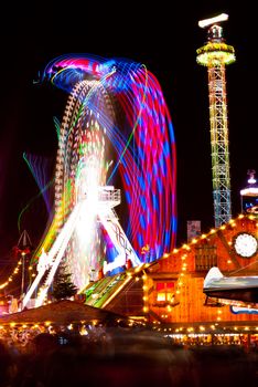 long exposure pictures of amusement park rides and wheels at night