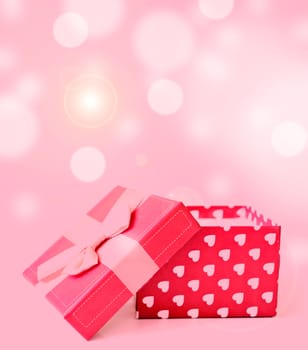 red gift box with hearts on bukeh background